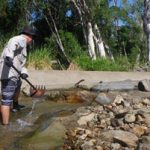 CS Environmental team member clears debris from the Forbes Road fishway.