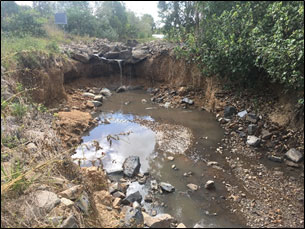 Significant scour hole resulting from flow events during tropical cyclone Debbie, which washed away the formalised spillway.